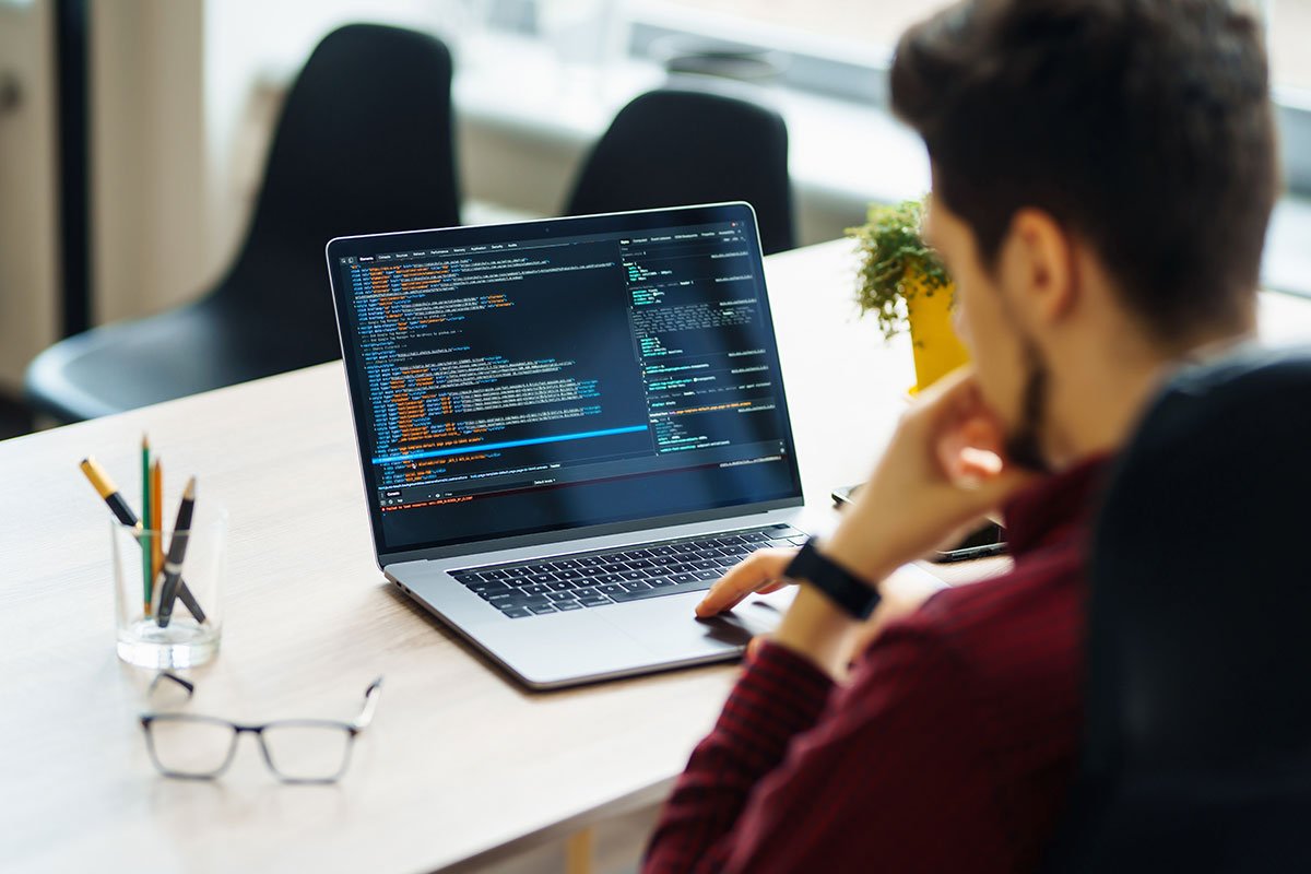 Developer coding on a laptop for Elementor development