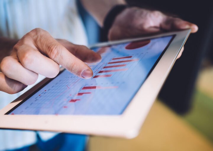 Person reviewing SEO friendly web development data on a tablet