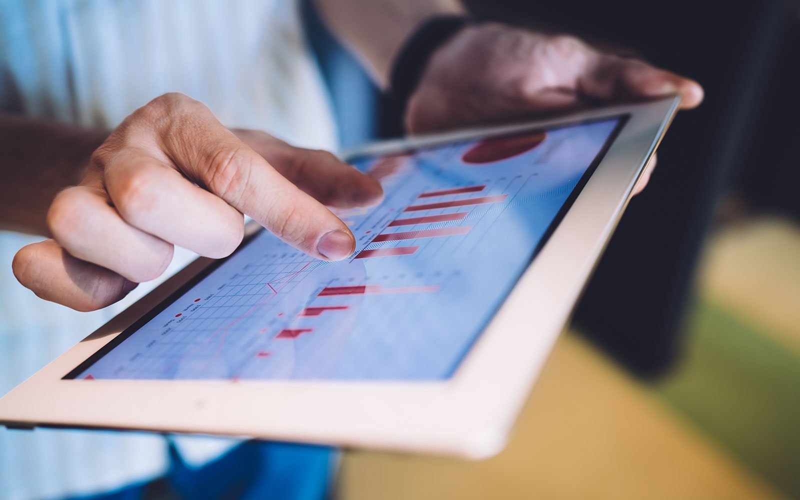 Person reviewing SEO friendly web development data on a tablet