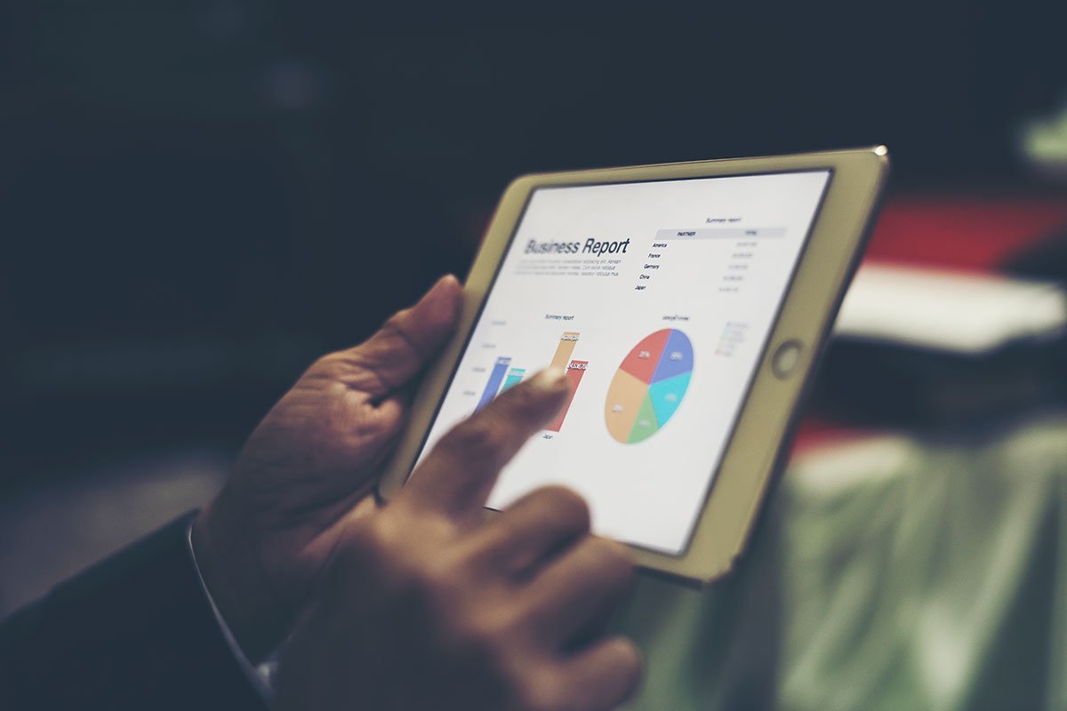 Person reviewing WordPress website maintenance report on tablet