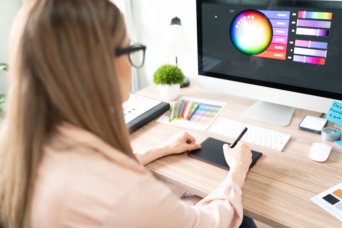 Designer using a graphics tablet for website redesign services.